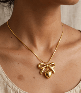 Woman wearing Gold Plated Bow Heart Pendant Necklace - CharmsCrafted