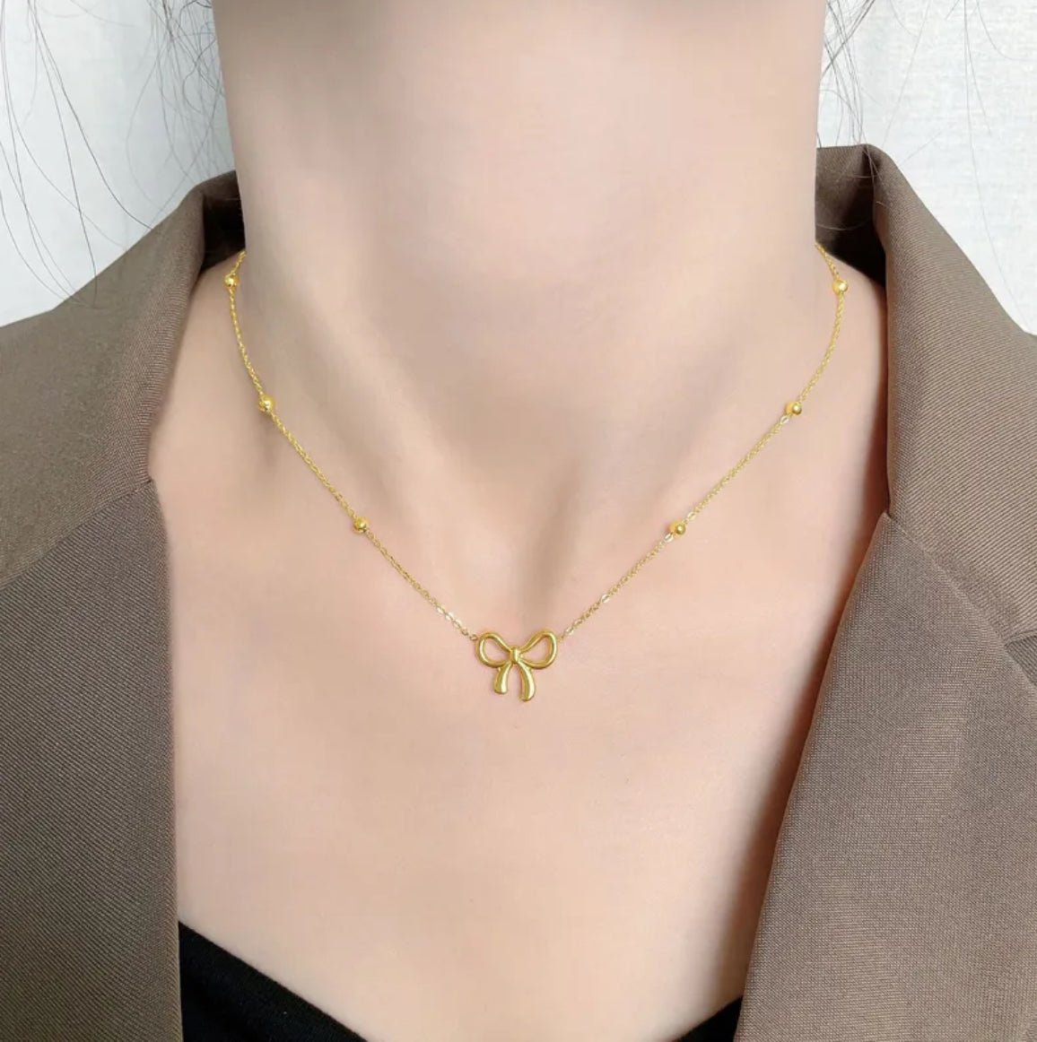 Woman wearing Sweet Bow Pendant Necklace - CharmsCrafted